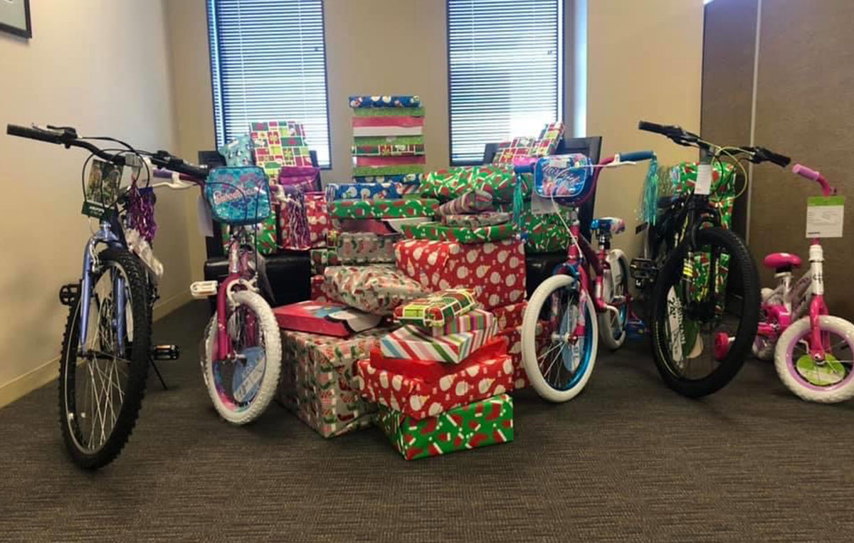 Children's bikes and wrapped Christmas gifts at the office for donation