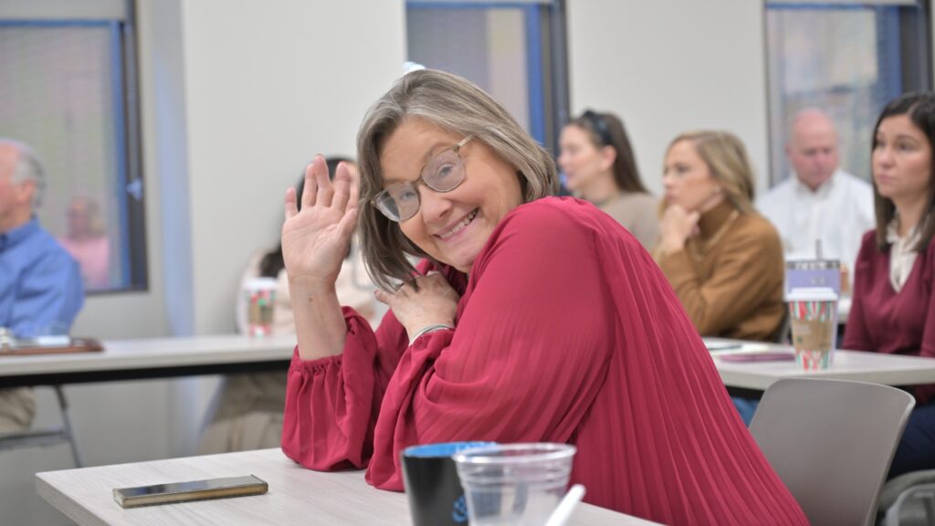 TM Floyd employee smiling and waving