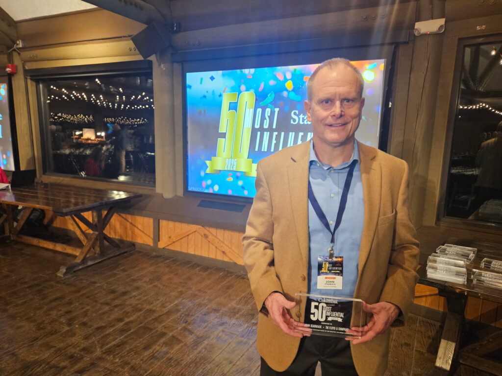 John Starmack, CEO of TMF, holding 50th influential leadership award