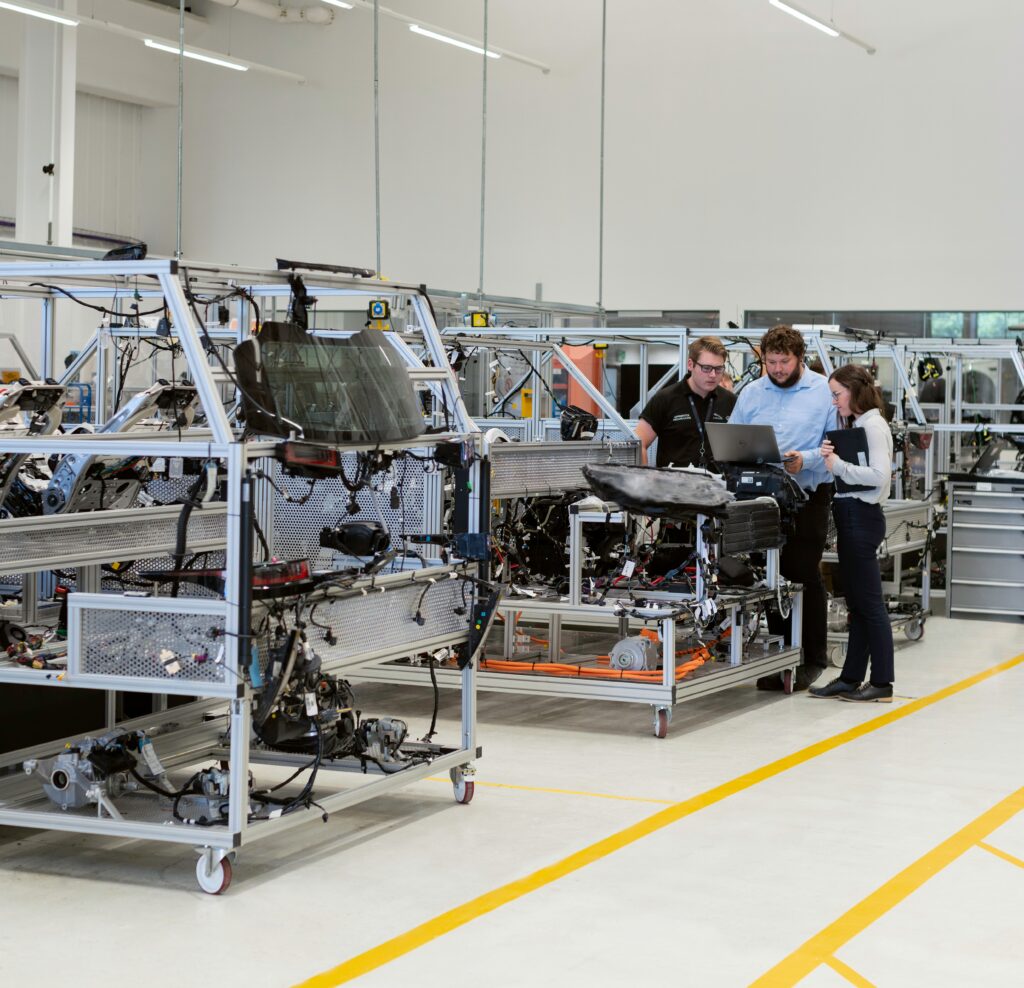 manufacturing photo with people standing around equipment