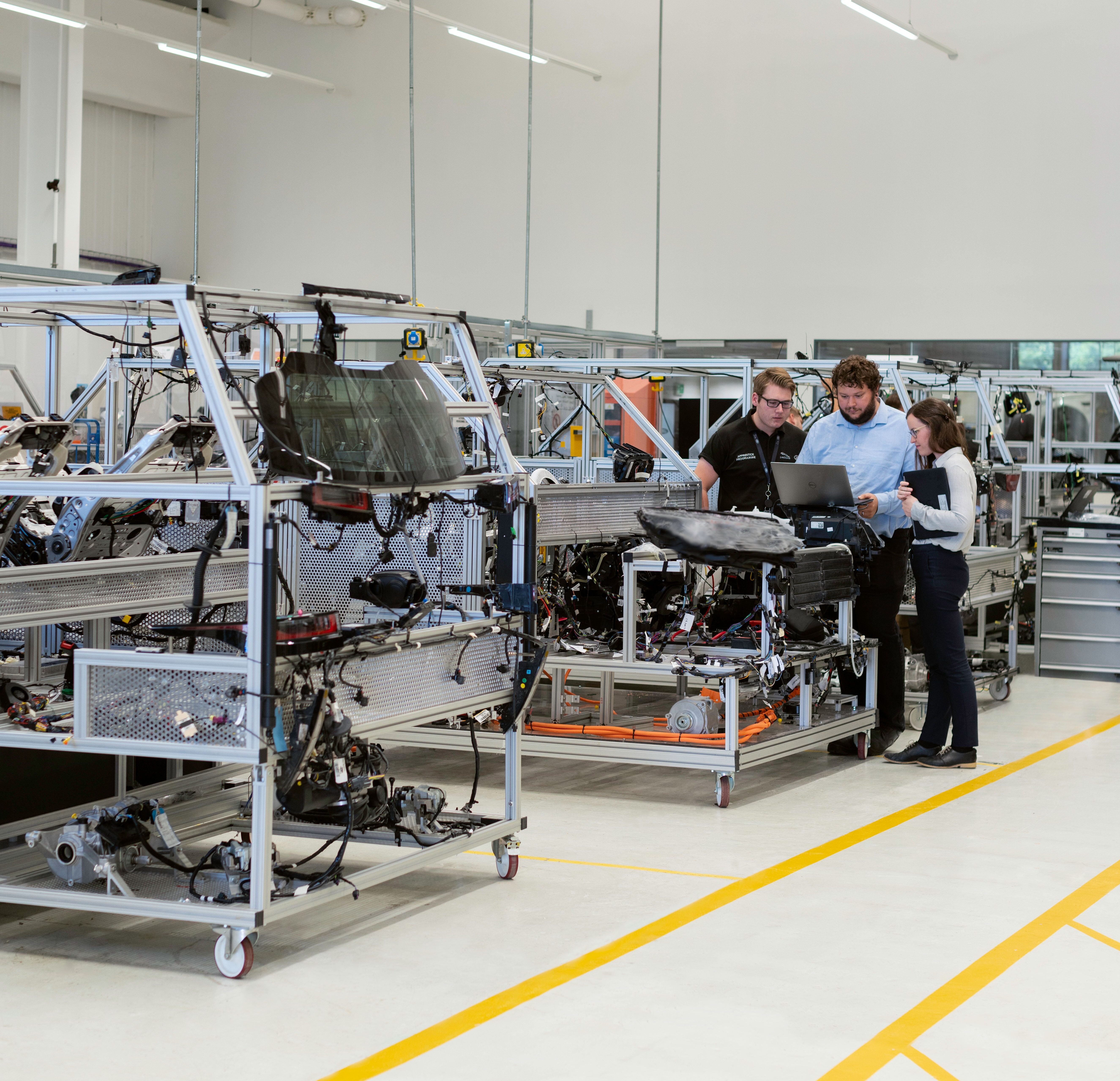 manufacturing photo with people standing around equipment